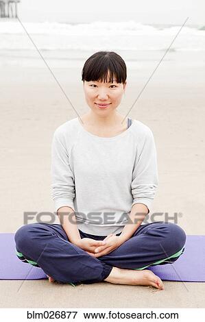 Chinese woman in lotus pose on yoga mat on beach View Large Photo Image Stock Photo - Chinese woman in lotus pose on yoga mat on beach. Fotosearch
