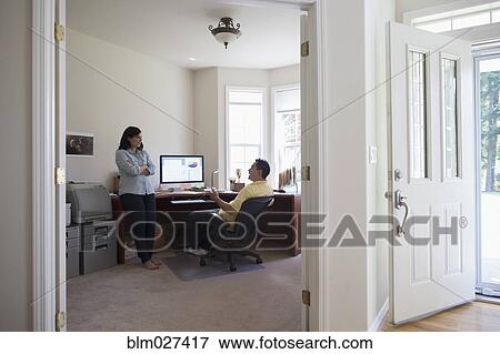 Stock Photo - Couple talking in home office. Fotosearch