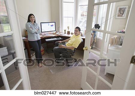 Stock Photo - Couple talking in home office. Fotosearch