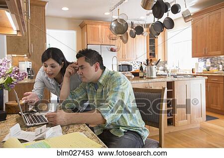 Couple using laptop in kitchen View Large Photo Image Stock Image - Couple using laptop in kitchen. Fotosearch