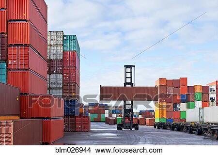 Picture - Crane lifting containers in shipyard. Fotosearch