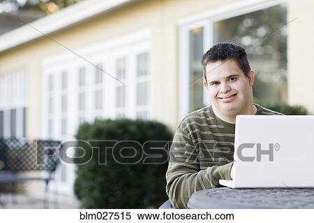 Disabled Caucasian man using laptop outdoors View Large Photo Image Stock Photography - Disabled Caucasian man using laptop outdoors. Fotosearch