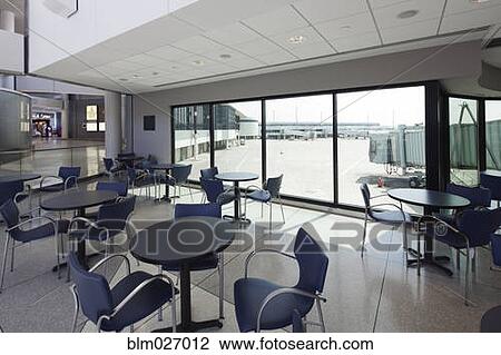 Stock Image - Empty cafe overlooking runway in airport. Fotosearch