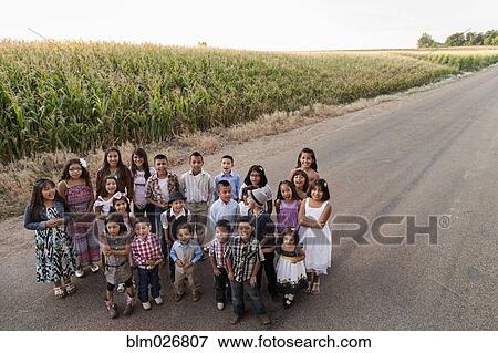 Family smiling together on rural road View Large Photo Image Stock Photo - Family smiling together on rural road. Fotosearch