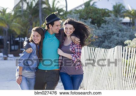 Friends walking on beach View Large Photo Image Stock Photograph - Friends walking on beach. Fotosearch