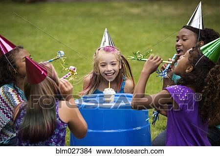 Girls celebrating birthday in backyard View Large Photo Image Picture - Girls celebrating birthday in backyard. Fotosearch