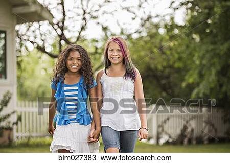 Girls holding hands in backyard View Large Photo Image Stock Image - Girls holding hands in backyard. Fotosearch