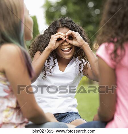 Girls making faces in backyard View Large Photo Image Stock Photography - Girls making faces in backyard. Fotosearch
