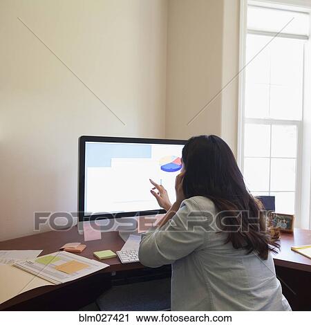 Hispanic businesswoman working on computer View Large Photo Image Stock Image - Hispanic businesswoman working on computer. Fotosearch