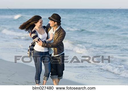 Hispanic couple walking on beach View Large Photo Image Stock Image - Hispanic couple walking on beach. Fotosearch