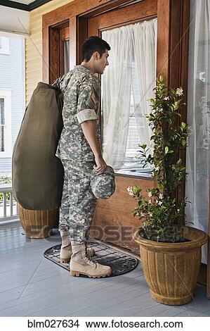 Picture - Hispanic soldier arriving home. Fotosearch