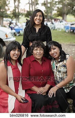 Stock Photograph - Hispanic women smiling outdoors. Fotosearch