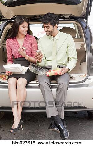 Indian business people having lunch in trunk of car View Large Photo Image Stock Photography - Indian business people having lunch in trunk of car. Fotosearch