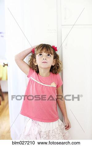 Mixed race girl measuring her height View Large Photo Image Stock Image - Mixed race girl measuring her height. Fotosearch