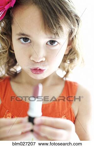 Mixed race girl playing with lipstick View Large Photo Image Stock Photo - Mixed race girl playing with lipstick. Fotosearch