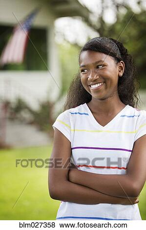 Stock Photo - Mixed race girl smiling outdoors. Fotosearch
