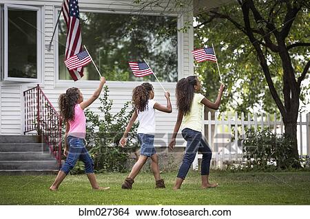 Mixed race girls marching with American flags View Large Photo Image Picture - Mixed race girls marching with American flags. Fotosearch