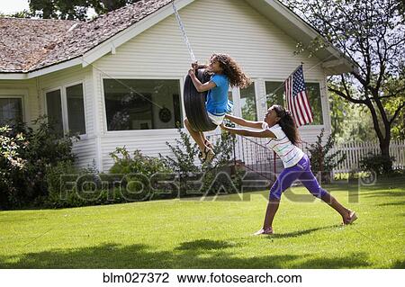 Mixed race girls playing on tire swing View Large Photo Image Stock Image - Mixed race girls playing on tire swing. Fotosearch