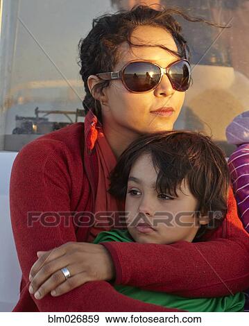 Stock Photo - Mixed race mother hugging son. Fotosearch