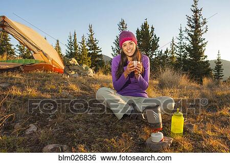 Stock Photograph - Mixed race woman camping. Fotosearch
