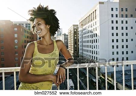 Mixed race woman on urban rooftop View Large Photo Image Stock Image - Mixed race woman on urban rooftop. Fotosearch