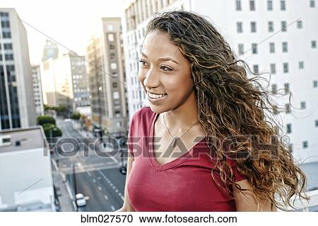 Mixed race woman on urban rooftop View Large Photo Image Stock Image - Mixed race woman on urban rooftop. Fotosearch