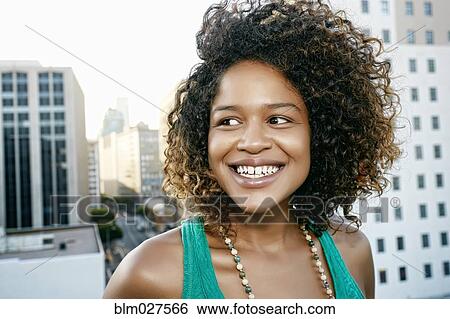 Stock Photograph - Mixed race woman on urban rooftop. Fotosearch