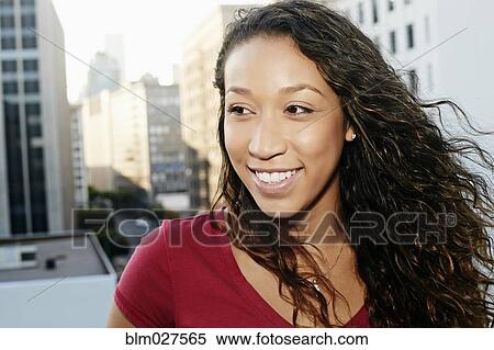 Stock Photography - Mixed race woman on urban rooftop. Fotosearch