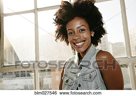 Mixed race woman smiling in window View Large Photo Image Stock Photograph - Mixed race woman smiling in window. Fotosearch