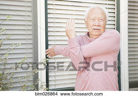 Older Asian man stretching outdoors View Large Photo Image Picture - Older Asian man stretching outdoors. Fotosearch