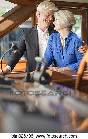 Older Caucasian couple hugging on yacht View Large Photo Image Stock Photograph - Older Caucasian couple hugging on yacht. Fotosearch
