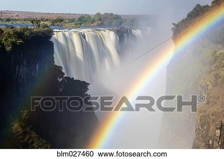 Rainbow stretching over Victoria Falls, Matabeleland North, Zimbabwe View Large Photo Image Stock Image - Rainbow stretching over Victoria Falls, Matabeleland North, Zimbabwe. Fotosearch