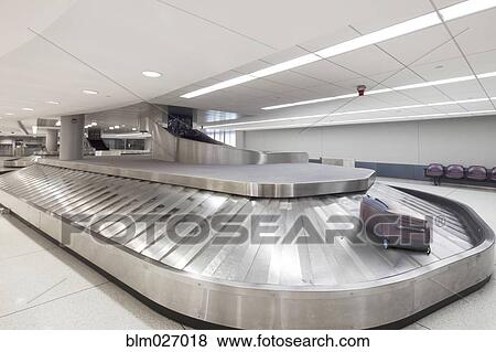 Suitcase on baggage claim carousel in airport View Large Photo Image Stock Photo - Suitcase on baggage claim carousel in airport. Fotosearch