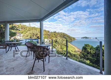 Table and chairs on balcony overlooking Bay of Islands, Paihia, New Zealand View Large Photo Image Stock Photo - Table and chairs on balcony overlooking Bay of Islands, Paihia, New Zealand. Fotosearch