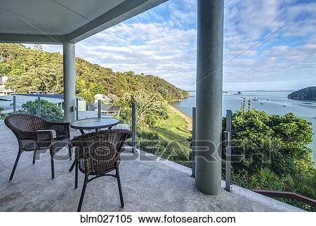 Table and chairs on balcony overlooking Bay of Islands, Paihia, New Zealand View Large Photo Image Stock Photography - Table and chairs on balcony overlooking Bay of Islands, Paihia, New Zealand. Fotosearch