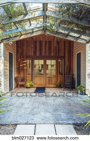 Stock Image - Vines growing over hotel doorway. Fotosearch