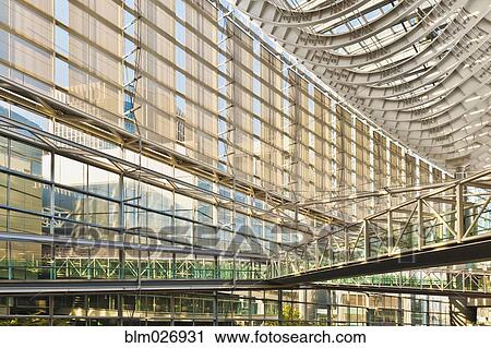 Stock Image - Walkway and glass walls of modern building. Fotosearch