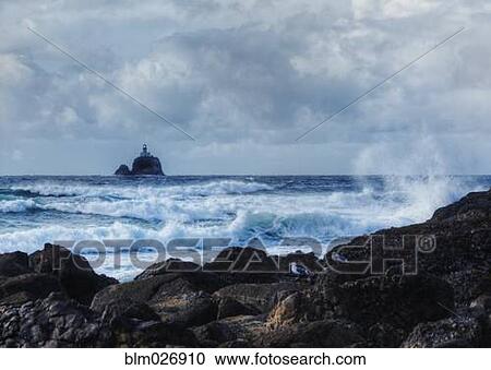 Waves crashing on rocky beach with lighthouse in distance, Tillamook, Oregon, United States View Large Photo Image Stock Image - Waves crashing on rocky beach with lighthouse in distance, Tillamook, Oregon, United States. Fotosearch