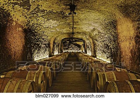 Stock Photo - Wine barrels in cave cellar. Fotosearch