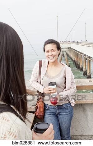 Women having coffee on wooden pier View Large Photo Image Stock Image - Women having coffee on wooden pier. Fotosearch