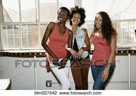Stock Image - Women smiling together. Fotosearch