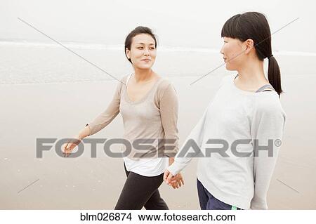 Women walking on beach View Large Photo Image Picture - Women walking on beach. Fotosearch