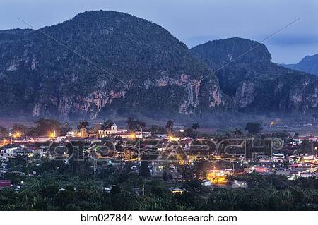 Picture - Aerial view of city rooftops lit up at night, Vinales, Pinar del Rio, Cuba. Fotosearch