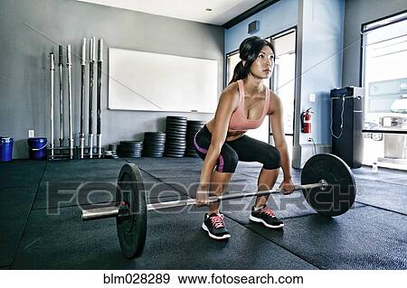 Asian woman working out in gym View Large Photo Image Stock Photo - Asian woman working out in gym. Fotosearch