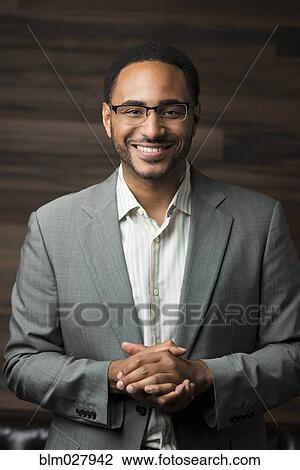 Stock Image - Black businessman smiling. Fotosearch