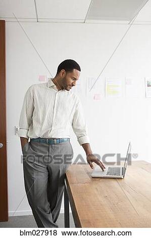 Stock Photo - Black businessman working in office. Fotosearch