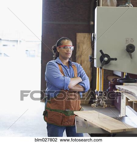 Stock Image - Black carpenter in workshop. Fotosearch