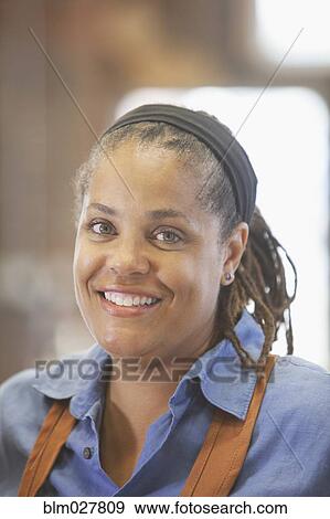 Stock Photo - Black carpenter smiling. Fotosearch