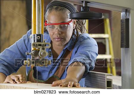 Black carpenter using cutting machine in workshop View Large Photo Image Stock Image - Black carpenter using cutting machine in workshop. Fotosearch