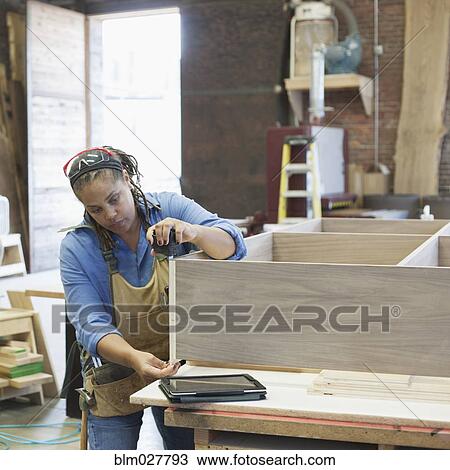 Black carpenter working in workshop View Large Photo Image Stock Image - Black carpenter working in workshop. Fotosearch